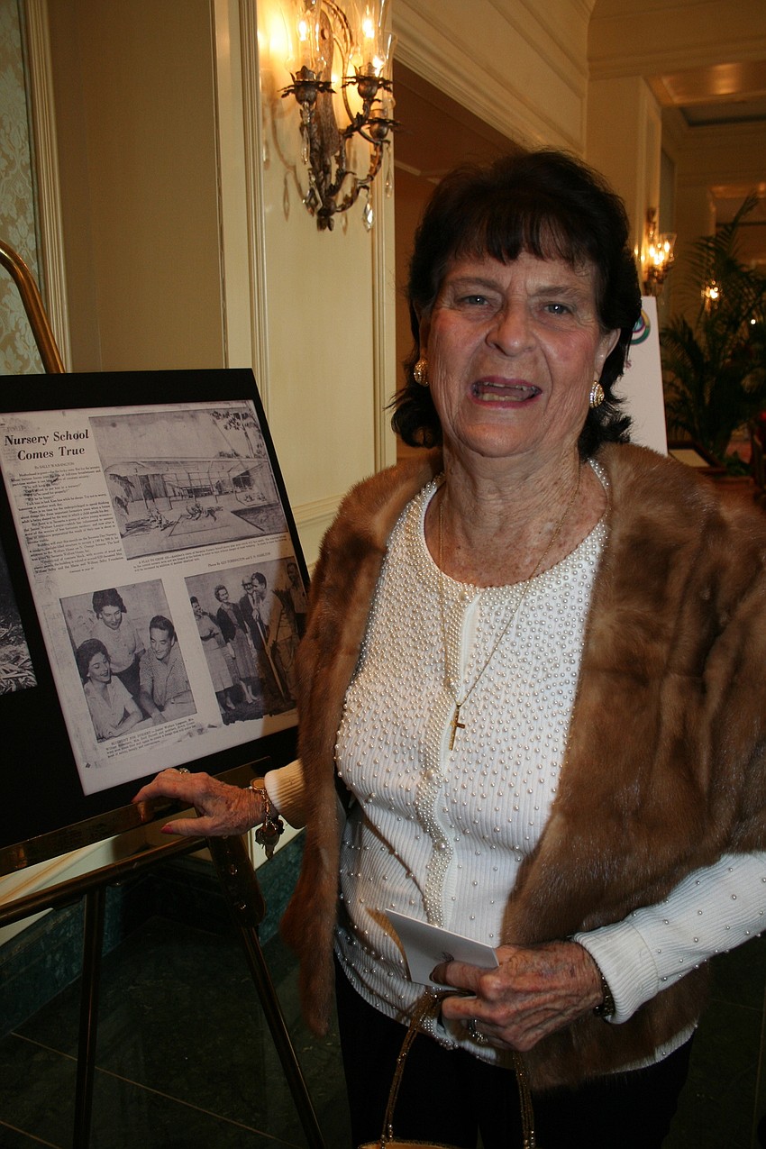 Bitsy Robertson points to her picture in an old article.