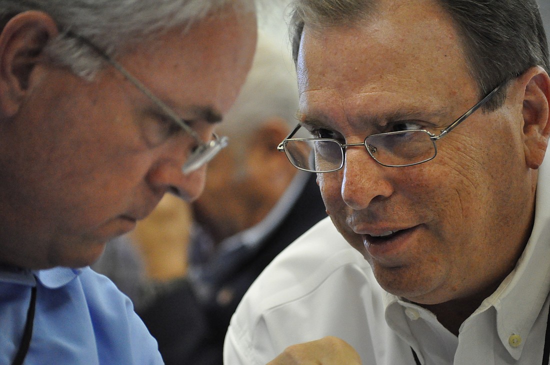 The Flagler County Chamber's Garry Lubi, right, discusses matters with the Palm Coast Observer's John Walsh at the fourth Economic Summit, in Flagler County.