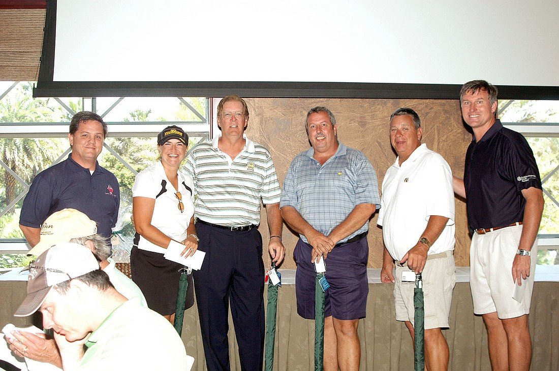 Joel Fallon (left), current club president; and John Subers (right), tournament co-director, pictured with the winning foursome of (left to right) Casey Kelley, Dick Caverly, Doug Wiley and Brad Meyers, of Hawyard Brown-Flagler Insurance. COURTESY PHOTO