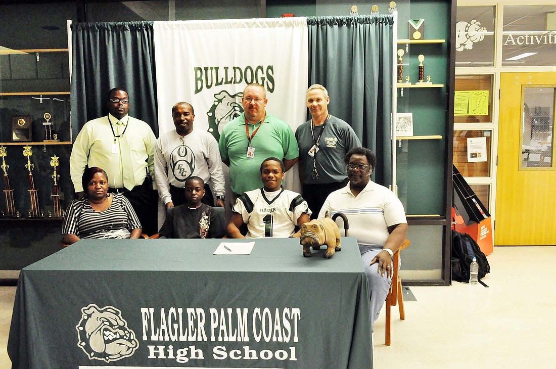 TaÃ¢â‚¬â„¢yaun McKinnon, pictured here with his family and FPC football coaches, signed April 27 with Bethel University, in Tennessee. PHOTO BY ANDREW O'BRIEN
