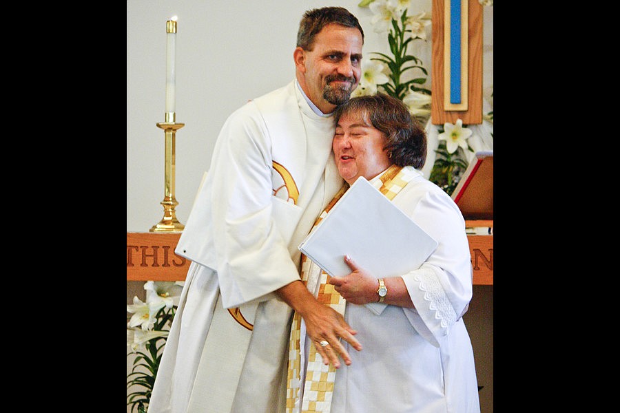 Dean of the Synod, the Rev. Art Weurtz, congratulates Pastor Pam Northrup.