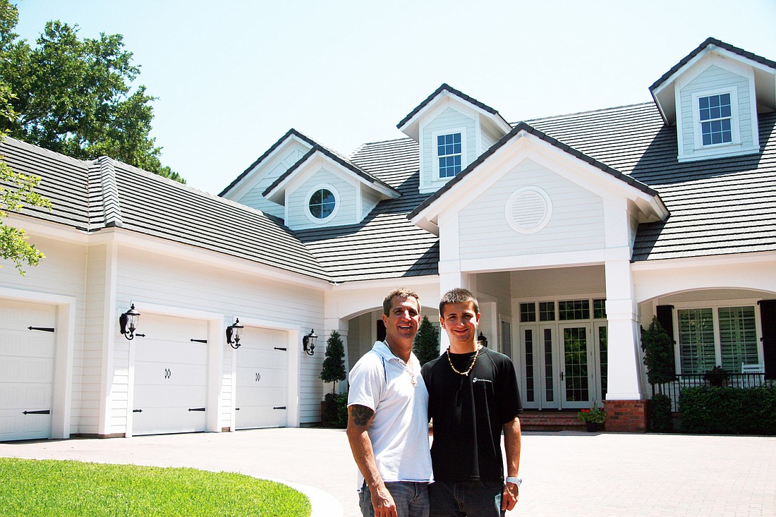 Stephen Rende (left) and son Tristan Rende (right), in front of a Charles Rinek Homes construction, just north of Island Estates on A1A. COURTESY PHOTO