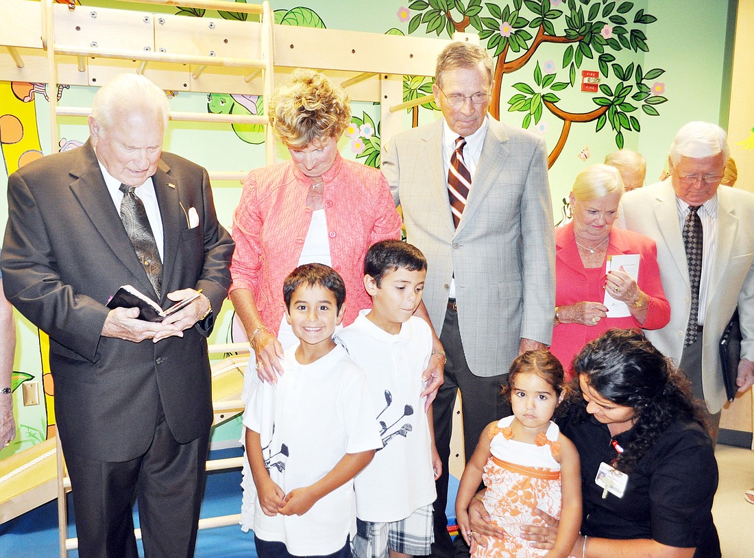 The Rev. Doran McCarty, of the Hammock Community Church, stands next to Sue and Peter Freytag and other guests as he blesses the Freytag ChildrenÃ¢â‚¬â„¢s Rehabilitation Center at Florida Hospital Flagler June 1.Ã‚Â COURTESY PHOTOS