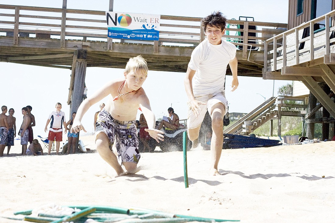Evan Ore and Sully Marigliano fight for the last flag while playing beach flags, a Jr. Lifeguard competition game at the Flagler Beach Jr. Lifeguard Competition Camp last summer. FILE PHOTO/SHANNA FORTIER