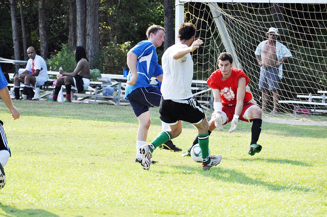 Greg Savy, of the Flagler Dawgs, blocks a shot in the semifinals May 4 against Black Lions in the Beaches Adult Soccer League 7v7 league. PHOTOS BY ANDREW O'BRIEN