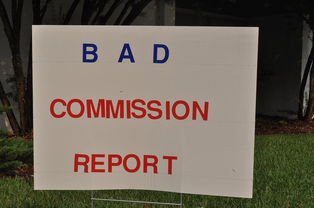 Signs such as this one were planted outside the Palm Coast Community Center before the June 14 special meeting.