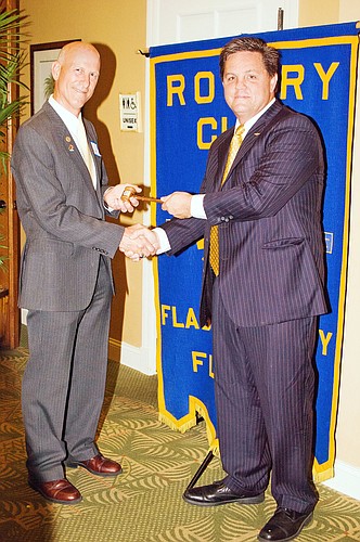New president Bill Butler accepts the gavel from Joel Fallon. COURTESY PHOTOS