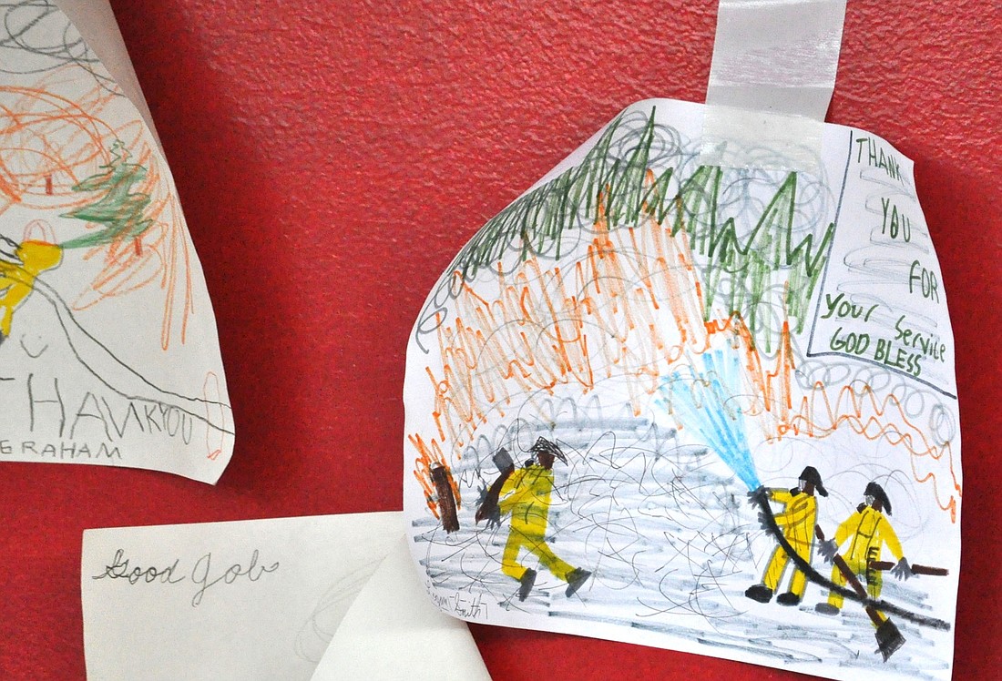 Residents have rallied behind the firefighters. This drawing was posted on a door at the Emergency Operations Center.