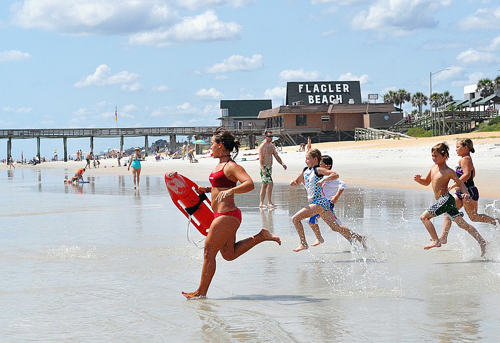 Flagler Beach Junior Lifeguard instructor Cheyenne Marquardt leads a group of campers in a water-entry drill.Ã‚Â COURTESY PHOTO