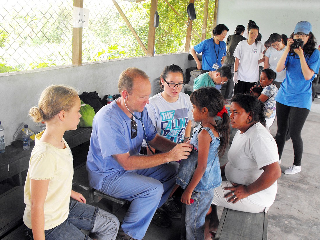 Steve Whitmer listens to a girlÃ¢â‚¬â„¢s lungs at Andrew Clinic, in Honduras. COURTESY PHOTOS