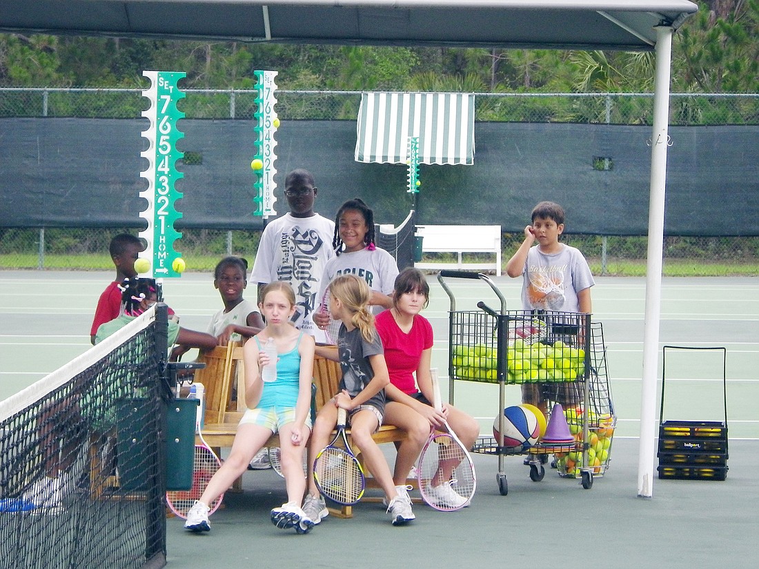 Tennis players take a break from working on their serves and backhands. COURTESY PHOTOS