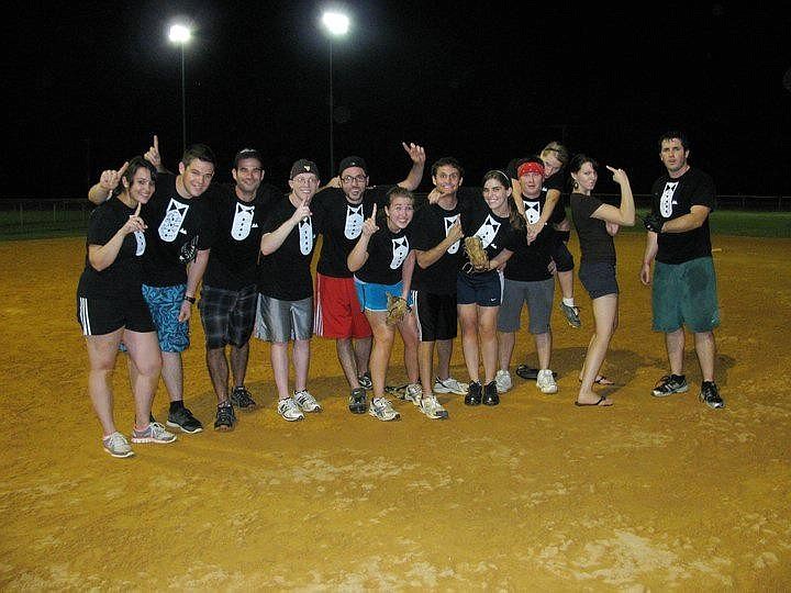 Business Casual celebrates after its first coed softball win. The team's final record: 2-10.