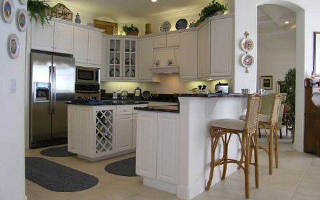 The home has a pool, a spa and a summer kitchen.