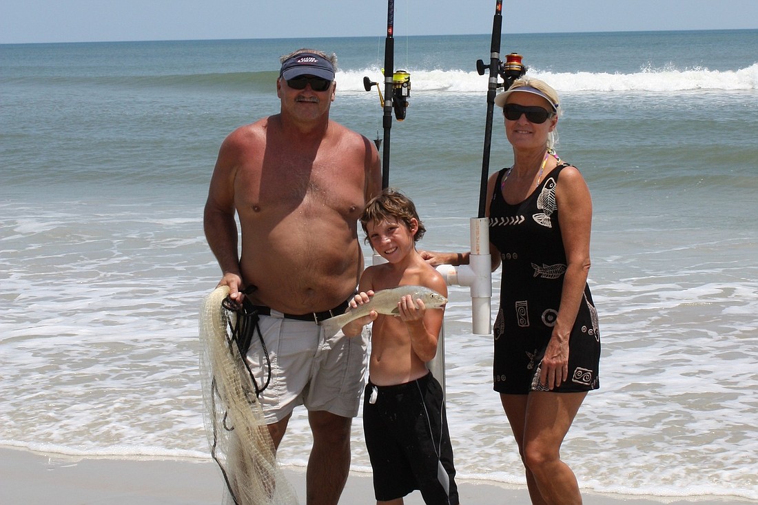 John Wilder and Darlene Mummah congratulate Colson Merkle, 11, on his whiting catch, at Flagler Beach.