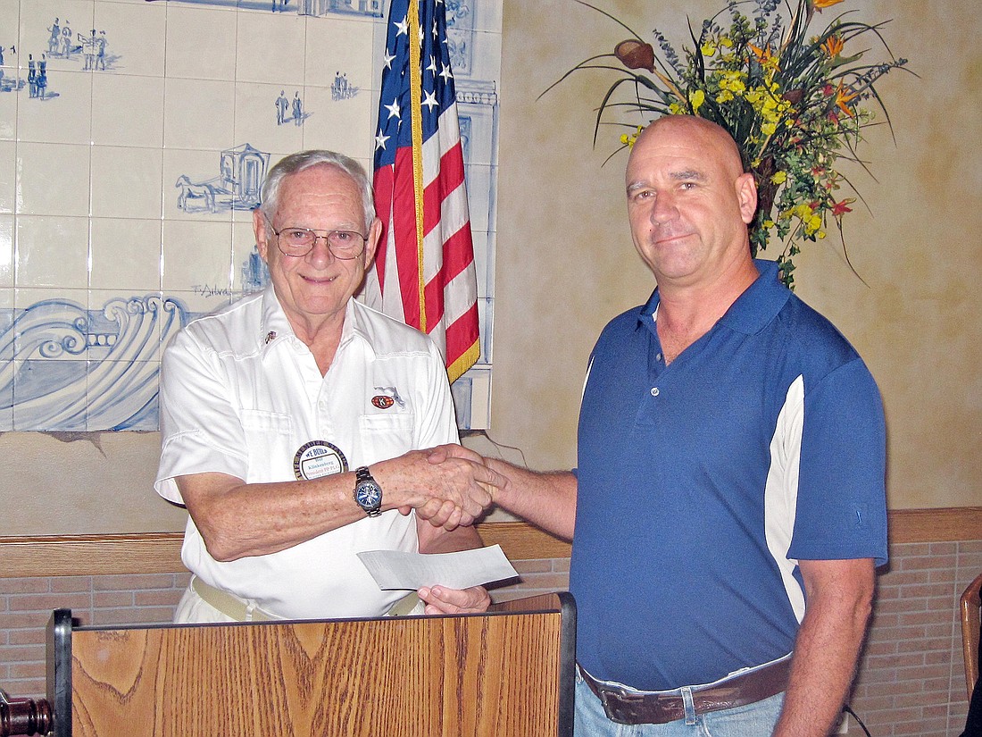 Joseph Wright, president of Quantum Electrical Contractors, presented a check to Bill Klinkenberg, president of the Flagler/Palm Coast Kiwanis Club. COURTESY PHOTOS