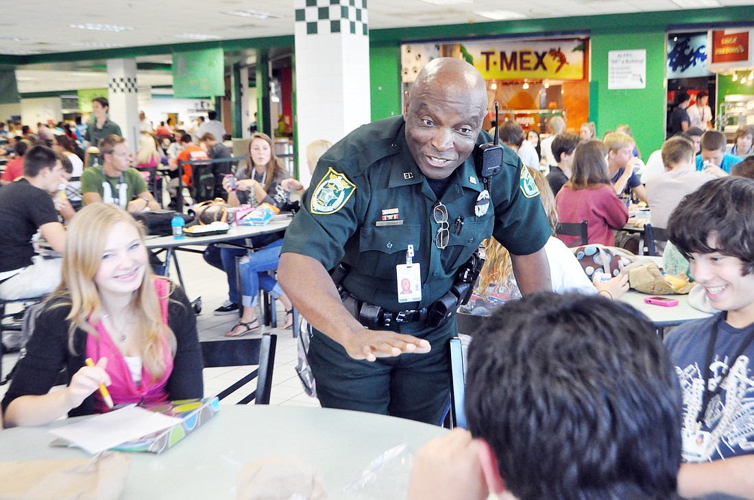 School Resource Deputy Calvin Grant spends time talking to a group of students at Flagler Palm Coast High School during lunch.