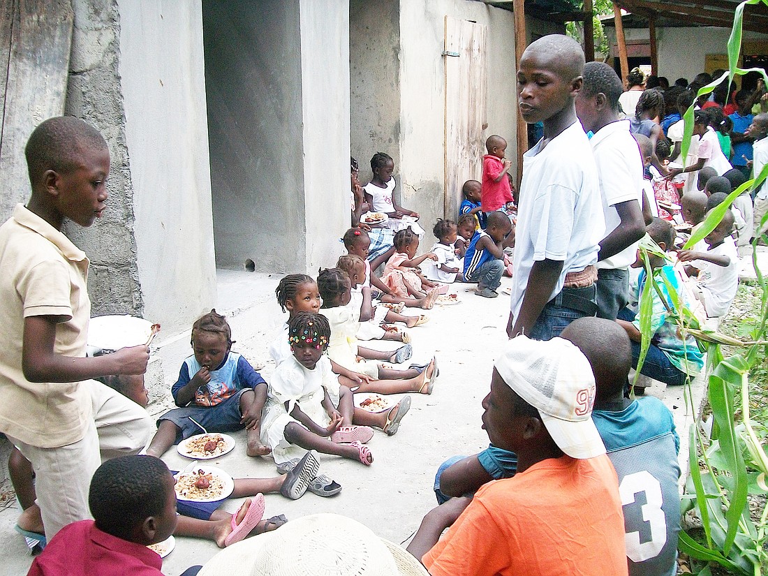 The Jean-Pierres cooked dinner for more than 150 homeless children during one of their visits to Haiti.