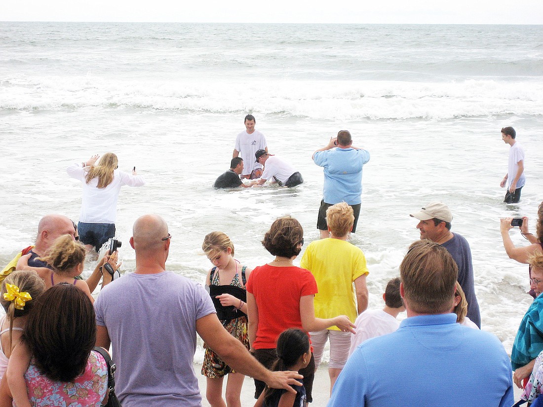 First Baptist Church baptized 25 new believers in its annual ocean baptism. COURTESY PHOTOS