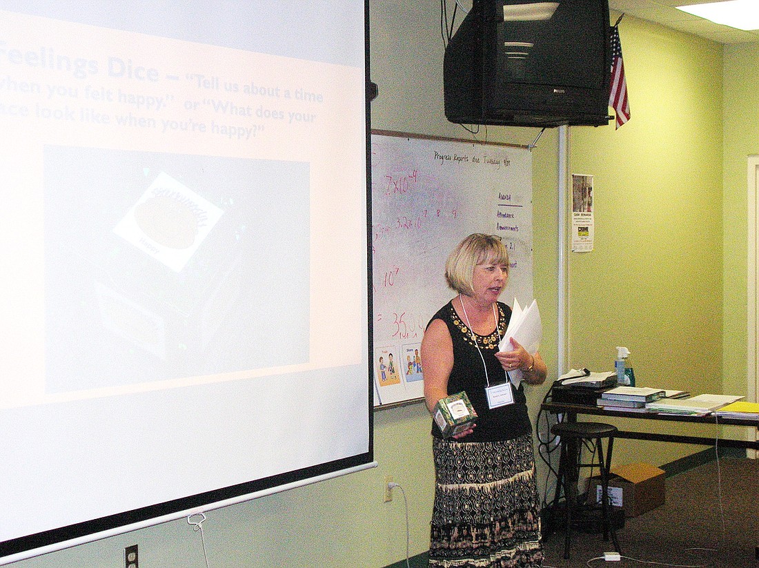 Sandy Johnson demonstrates the use of Ã¢â‚¬Å“Feelings DiceÃ¢â‚¬Â during her presentation at the conference. COURTESY PHOTO