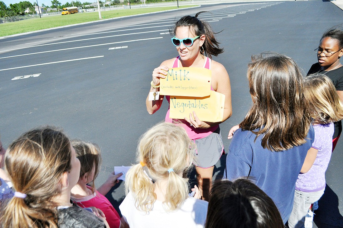 Donia Rinaldi, Girls on the Run coach, talks to students about healthy food choices. PHOTOS BY SHANNA FORTIER