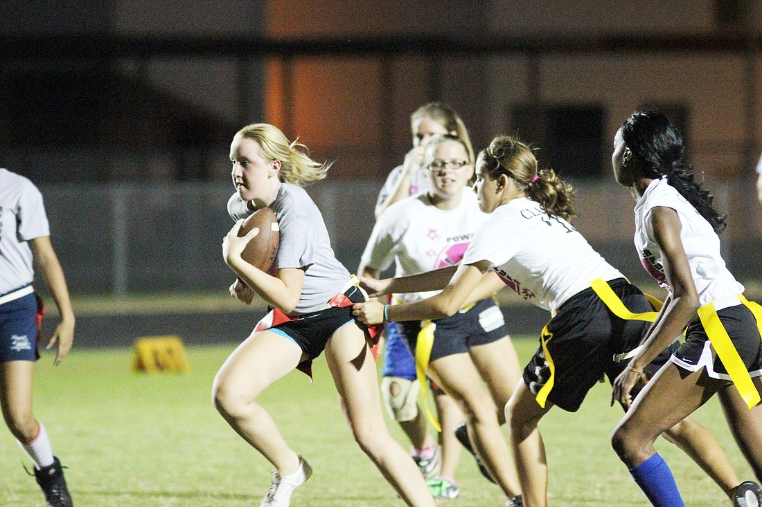 Savannah Rose, freshman, tries to outrun the juniors in their matchup. The freshmen lost, 42-7. PHOTOS BY SHANNA FORTIER