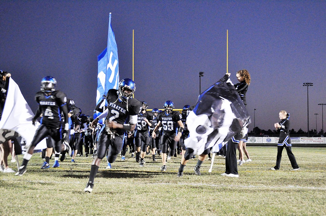 Seniors Mark Pugh (2) and Dorian Stanard (4) lead Matanzas onto Pirate Field for the final time Friday, Nov. 4, for Senior Night. PHOTOS BY ANDREW O'BRIEN