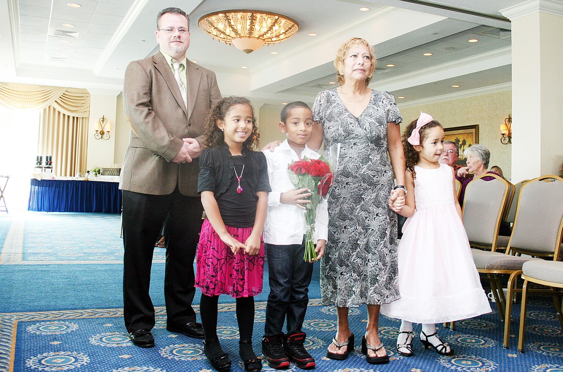 Social worker James Yorke and adoptive parent Francisca Garcia, with her children Kyrice, 7, Juliza, 6, Ava, 4.