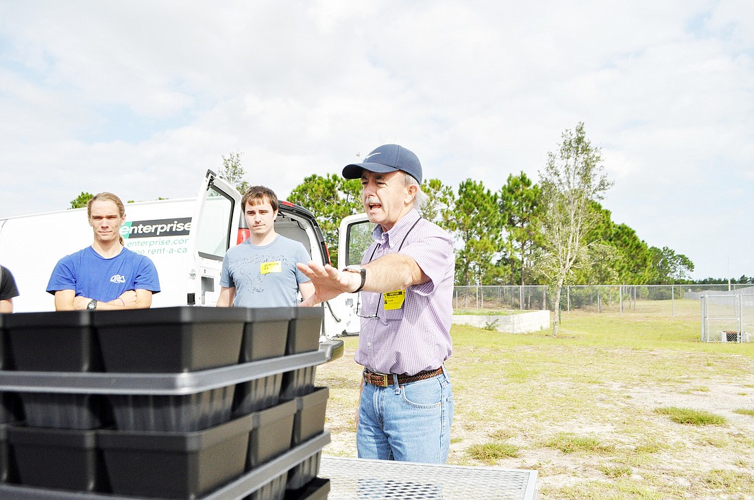 Dr. Michael Kane, assistant chairman and professor in the environmental horticulture department at the University of Florida, explains the sea oat planting process to Matanzas High School students. PHOTOS BY SHANNA FORTIER