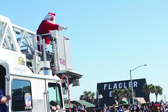 Santa will parachute onto the beach 1 p.m. Saturday, before assuming his spot in the parade.