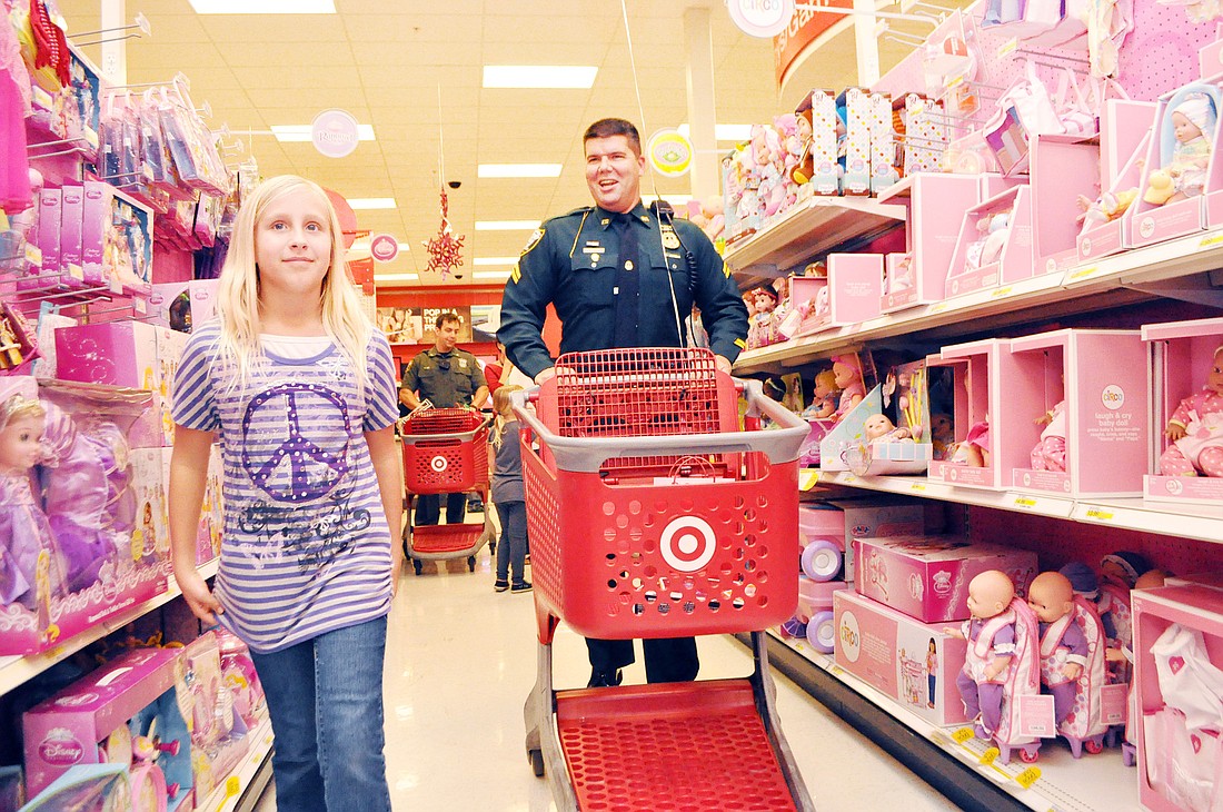 Brianna Day browses the doll aisle at Target with Deputy Mike Lagana, during Christmas with a Deputy.