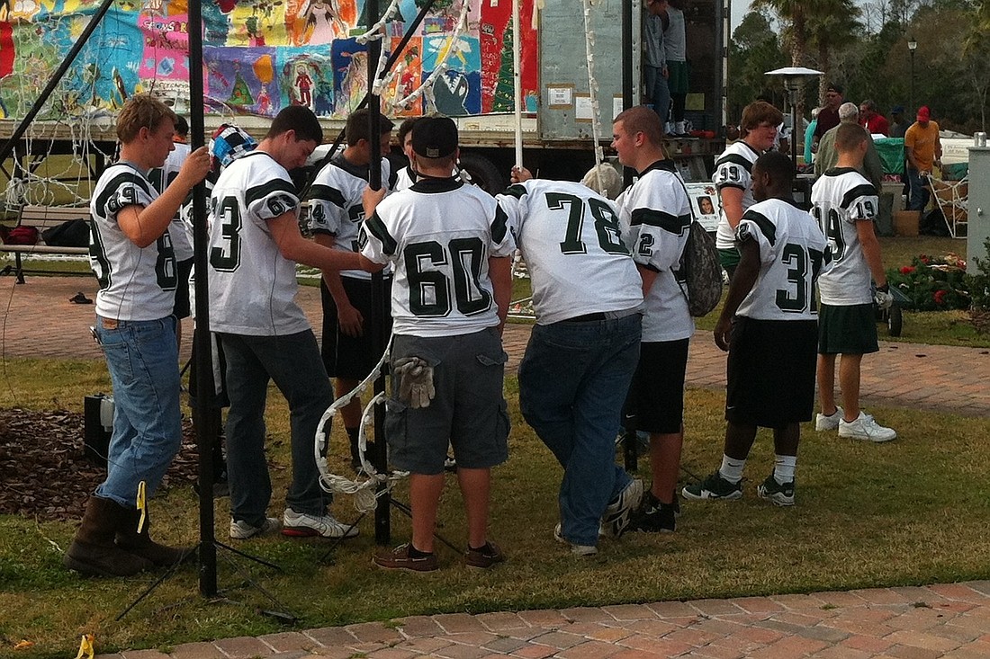The Flagler Palm Coast Bulldogs football team helped take down holiday decorations Jan. 7, at Town Center.