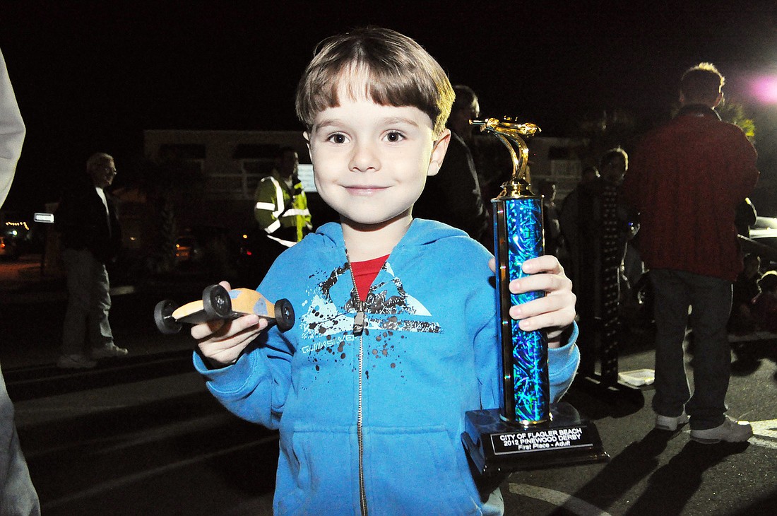 James Triplett and his car Ã¢â‚¬Å“Orange CrushÃ¢â‚¬Â won first place in the Pinewood Derby for the kids division. PHOTOS BY SHANNA FORTIER