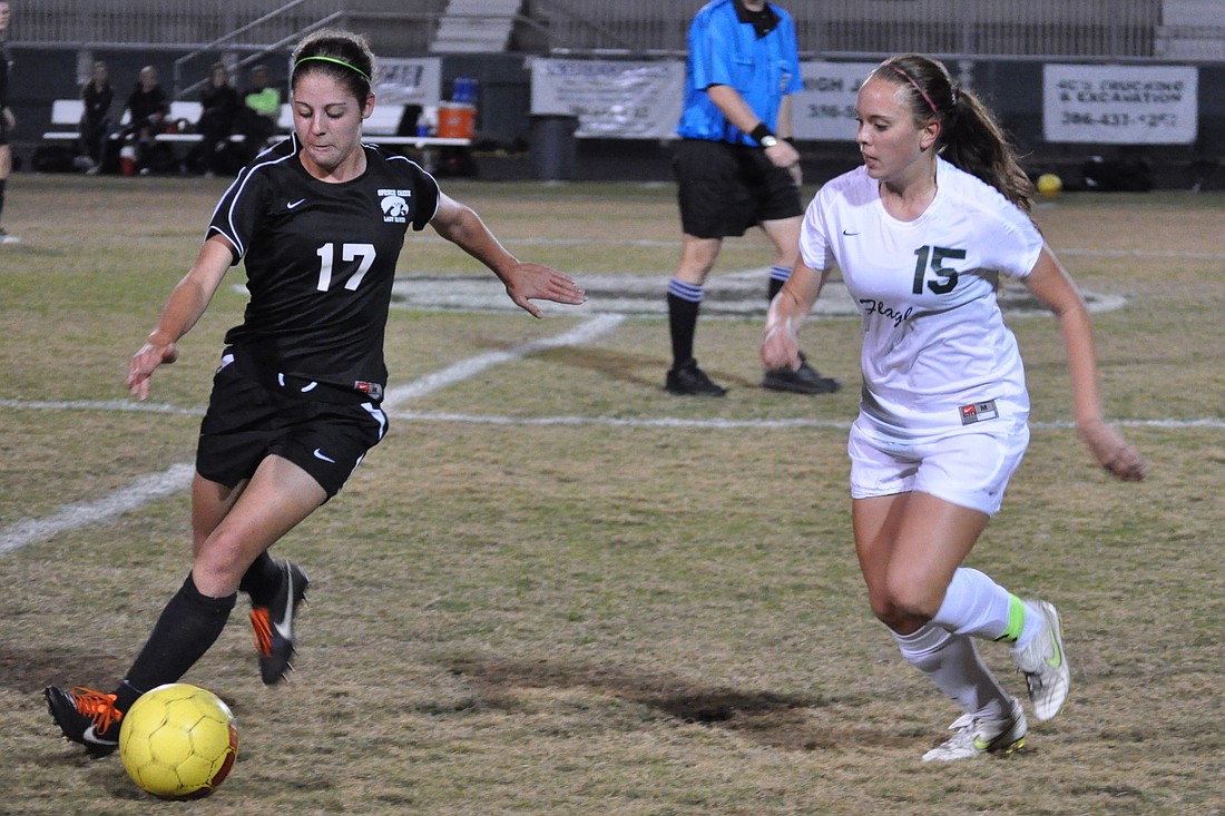 Flagler Palm Coast senior defender Brooke Landry (right) defends against a Spruce Creek attacker Friday night, in the District 2-5A championship.