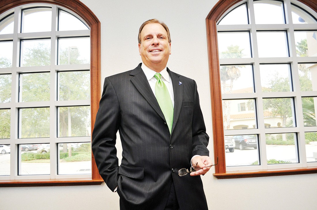 Garry Lubi, pictured here in his office, was installed as the new chairman of the Flagler chamber.