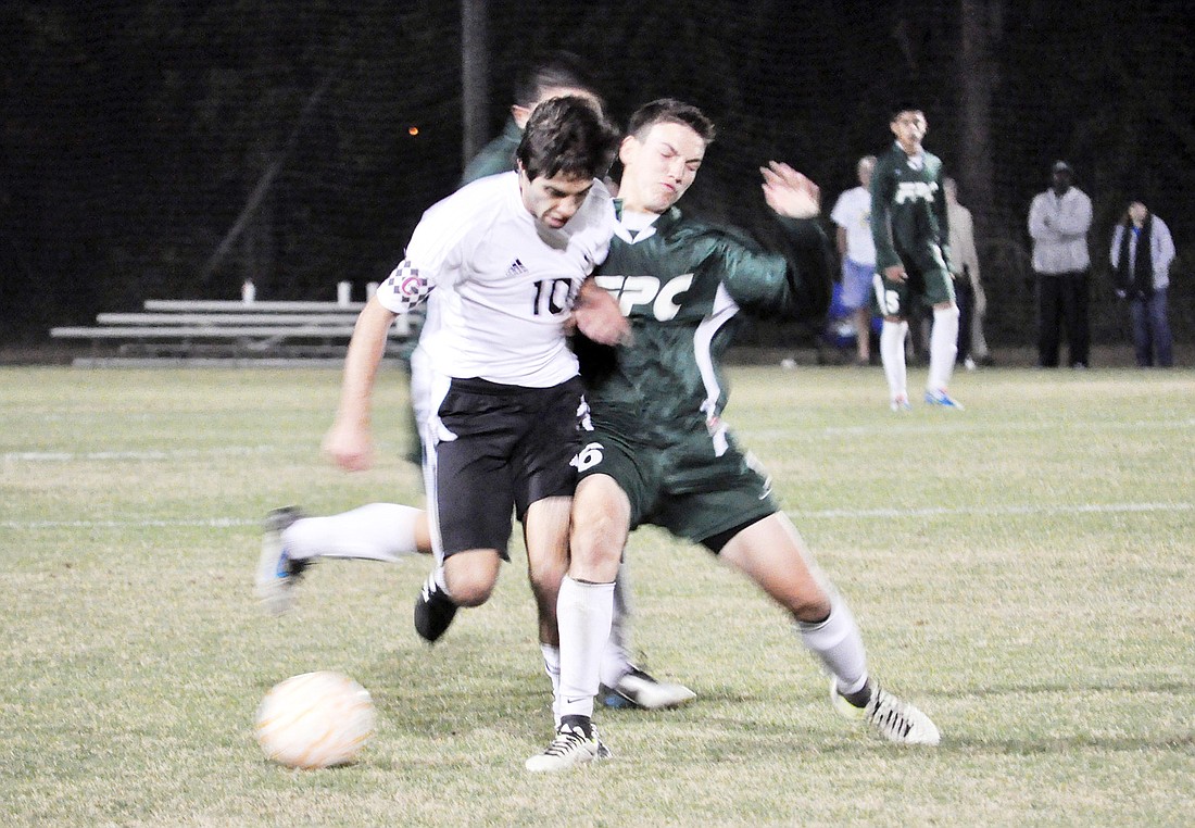 Flagler Palm Coast midfielder Nathan Monsanto (right) tackles a Spruce Creek player Friday, Jan. 27, in the District 2-5A championship. PHOTO BY ANDREW O'BRIEN