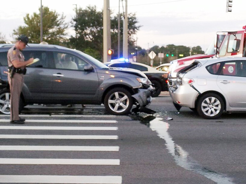 Christa Santamaria-Koppell was driving the Subaru on the right. Note the trail of liquid running between the two cars.