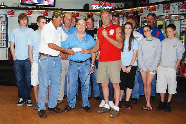 Commander Wayne Zack and Riders President Pete Isaac from BunnellÃ¢â‚¬â„¢s American Veterans Post 113 presented a check to Jack Howell, center, CEO of Teens in Flight. COURTESY PHOTO