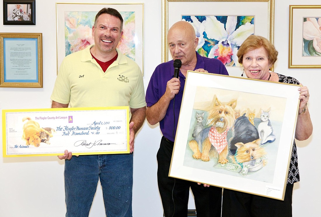 Jef Hale, Flagler County Humane Society director, accepts a check from Bob Ammon, FCAL president, and Joan Howard. COURTESY PHOTO
