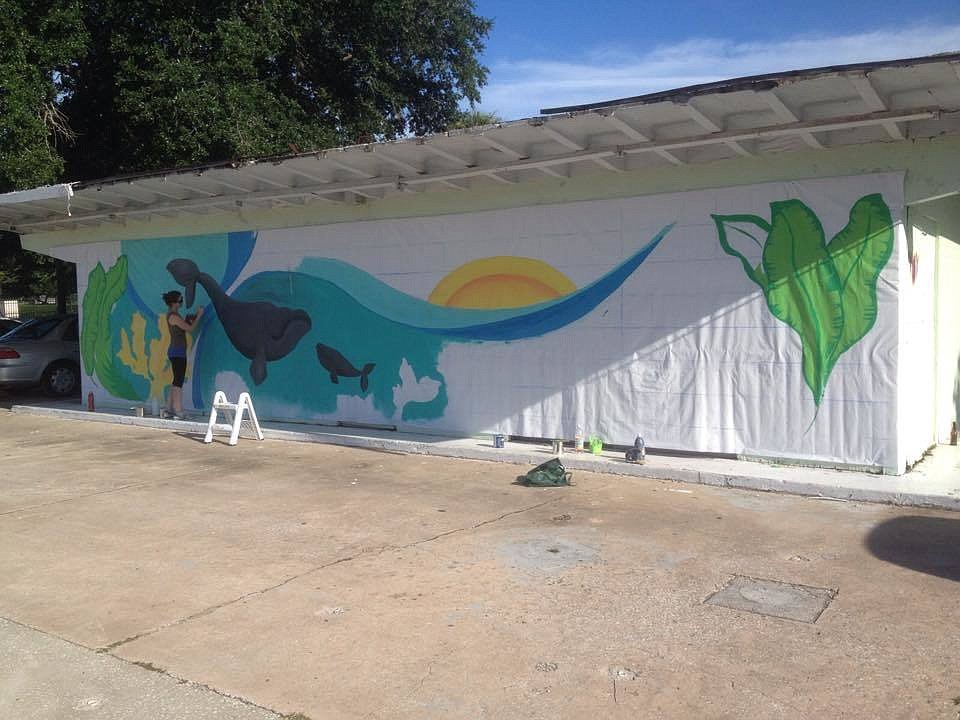 Kristin Heron painted a mural on a vacant building on West Granada Boulevard for the first Granada Grand Festival of the Arts in 2014 (Photo courtesy of the Ormond Beach Arts District).