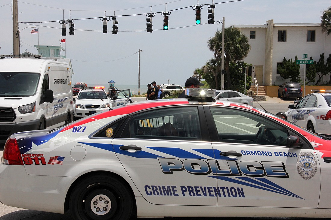 Ormond Beach Police closed State Road A1A for a short time this morning, after the possible firing of a gun at one of their cruisers. The car involved is behind the white van. Photo by Jacque Estes