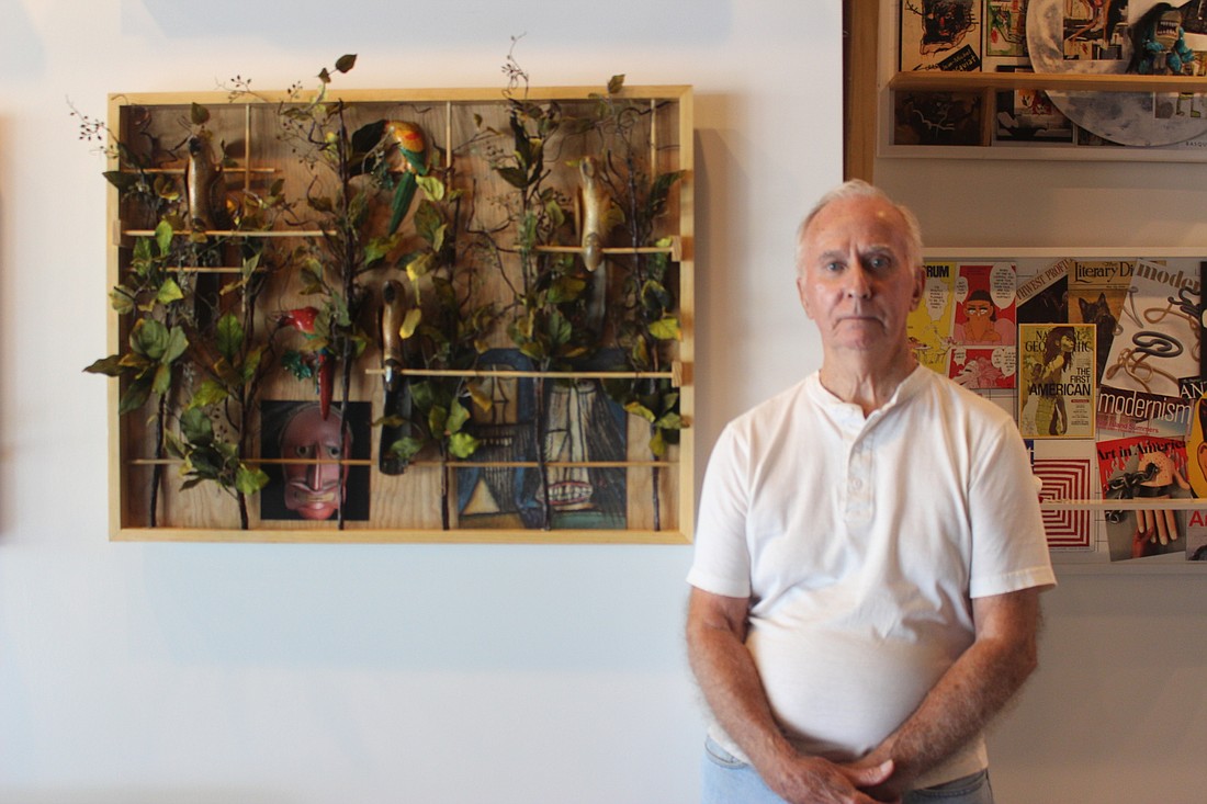 Ron Berkheimer stands in front of his piece "Into the Forest" displayed inside Frame of Mind.