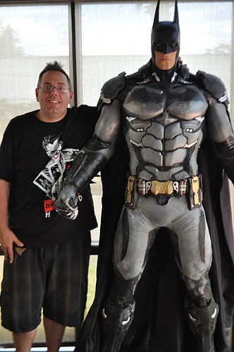 Owner Marco Fallatto stands next to a life-sized Batman inside the new Gotham City Pizza. Photo by Jarleene Almenas.