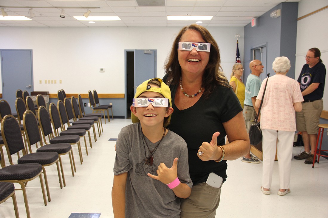 Avi and Lauren Jack pose with their new ISO certified solar eclipse glasses after a presentation at the Ormond Beach library on Monday. Photo by Jacque Estes