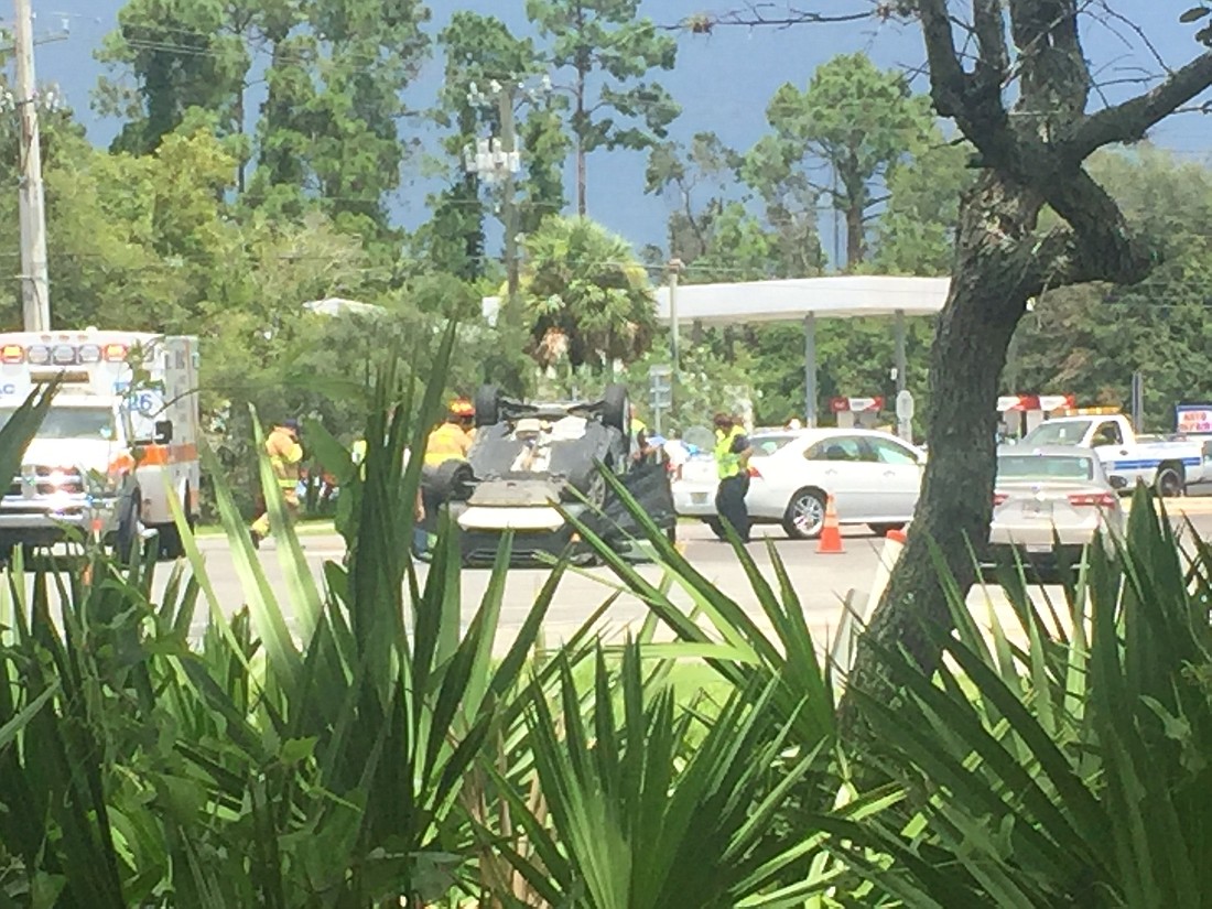 An SUV flipped over on State Road 40 after a sedan crashed into its passenger side at approximately 1:24 p.m. on Monday, Aug. 7. Photo by Jarleene Almenas.
