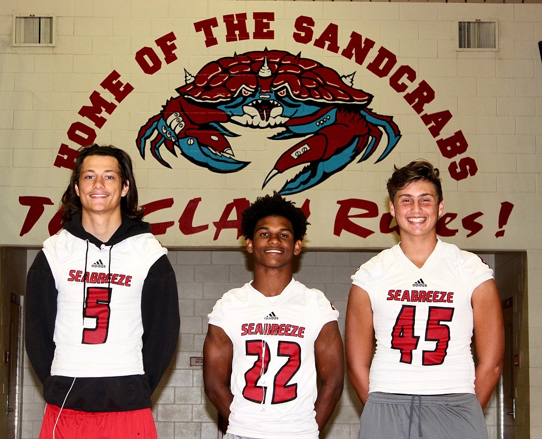 Seabreeze football players Jalen Wilson, Isaac Mott and Joseph Justice. Photo by Ray Boone