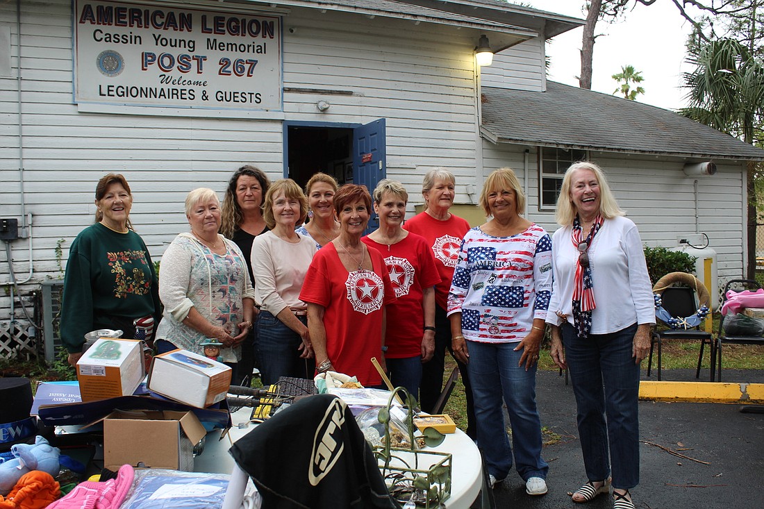 American Legion Auxiliary volunteers stand in front of legion post 267 for their annual yard sale on Nov. 11. Photo by Jarleene Almenas