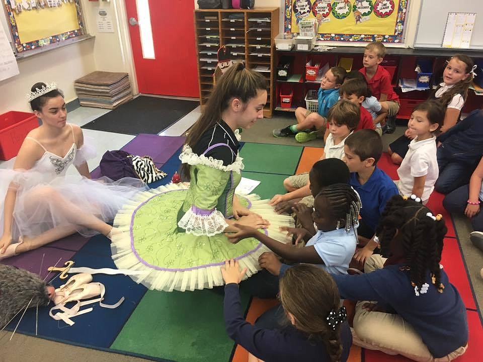 Annalisa Peburn and her sister Gabby show off some of the Nutcracker costumes in a second grade classroom at Osceola Elementary. Photo courtesy of Janet Peburn
