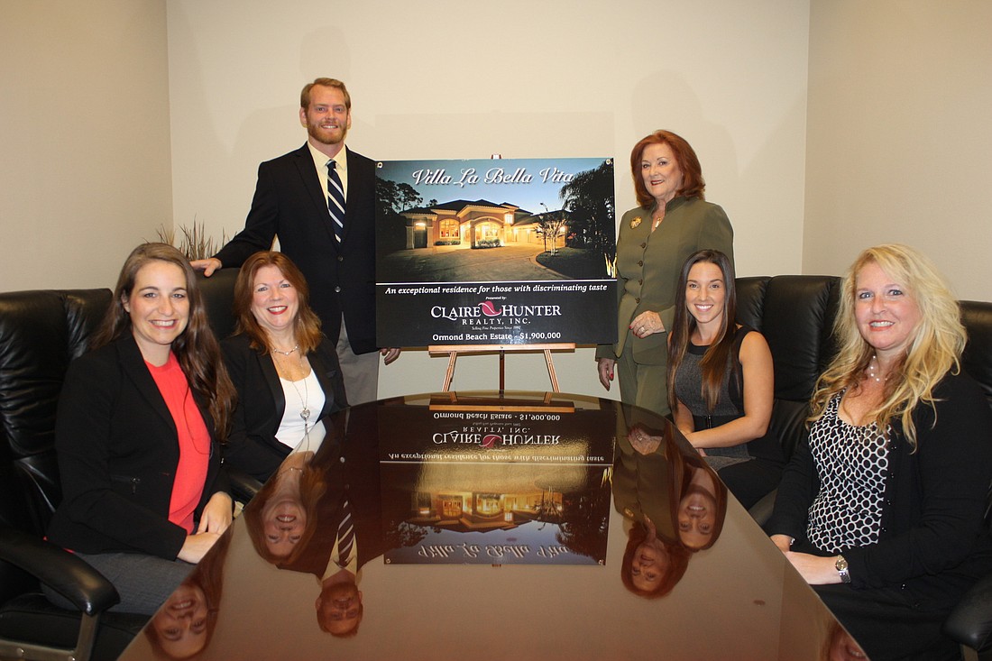 Shown are Associates Michelle James and Bonnie Condorodis; General Manager/Broker Brian Hunter; Broker/Owner Claire Hunter, and Associates Brittany Gercken and Delissa Taylor Day. Photo by Wayne Grant