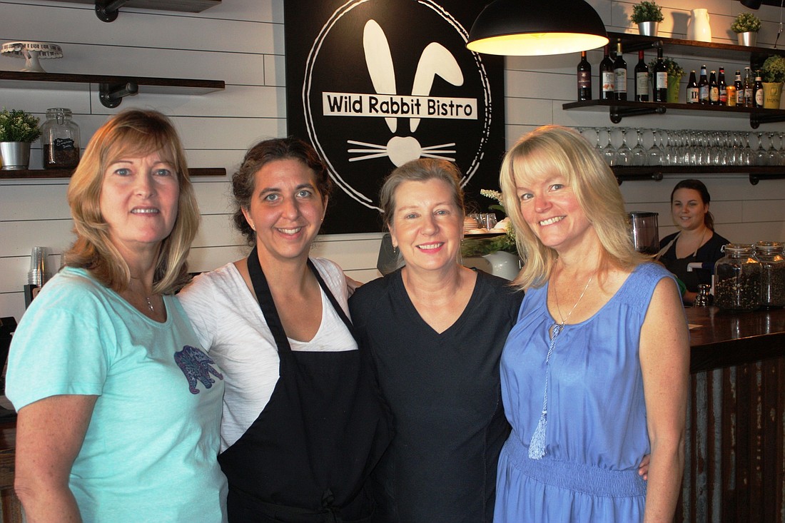 Three residents of the Ormond Beach area convinced Wild Rabbit Bistro owners to open in the city. Shown are Beth Shumaker; restaurant owner Laura Hannan; Susan Thomas; and Stacy Baldi. Photo by Wayne Grant