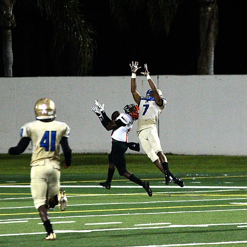 Mainland safety John Huggins leaps for an interception attempt against Carol City. Photo by Ray Boone
